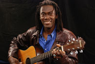 Izmskzm playing a guitar, Seated. Topanga sessions.